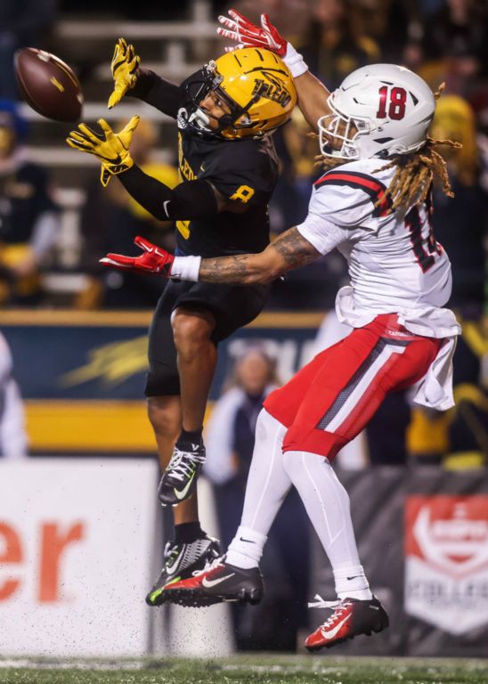 Sports - 3rd place - Toledo Rockets wide receiver Devin Maddox (left) catches a pass and spins away for a touchdown while blanketed by Ball State Cardinals safety Trenton Hatfield during the second quarter of a Mid-American Conference divisional matchup at the Glass Bowl in Toledo.  (Isaac Ritchey / The Blade)