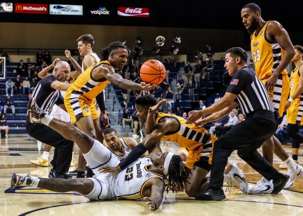 Sports - HM - Toledo Rockets guard Tyler Cochran (23) continues to go after a loose ball from the court as officials sprint to break up the jumbled players in a non-conference game against the Valparaiso Beacons at John F. Savage Arena in Toledo. (Isaac Ritchey / The Blade)