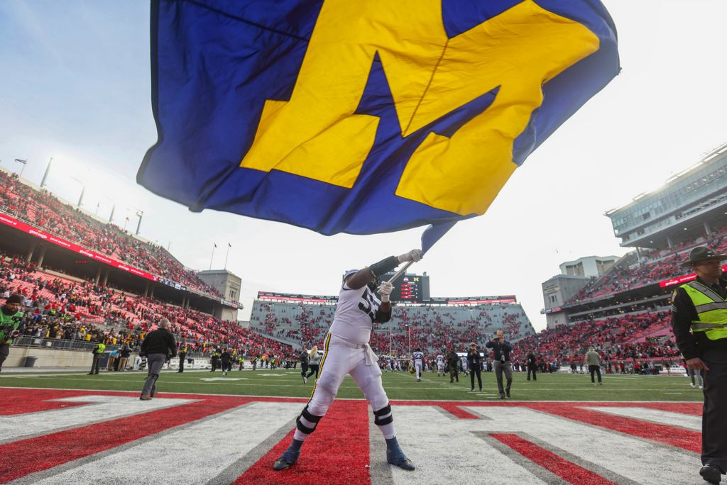 Story - 2nd place - Michigan’s Trente Jones waves the Michigan flag after defeating Ohio State, 45-23 at Ohio Stadium in Columbus.  (Rebecca Benson / The Blade)