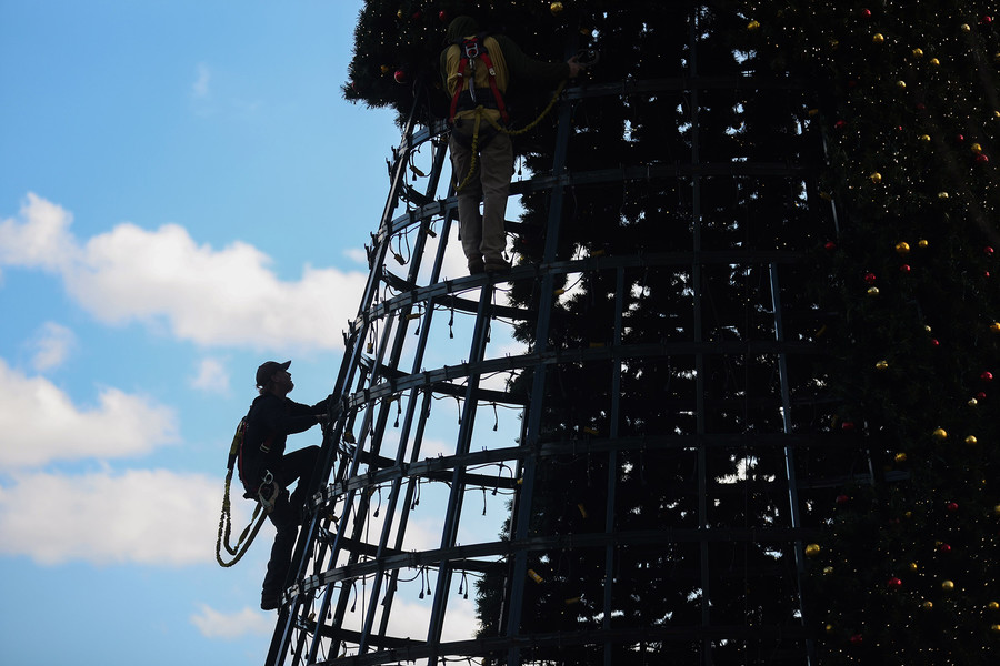 Feature - 2nd place - Workers assemble the giant Christmas tree at Promenade Park in downtown Toledo. (Rebecca Benson / The Blade)