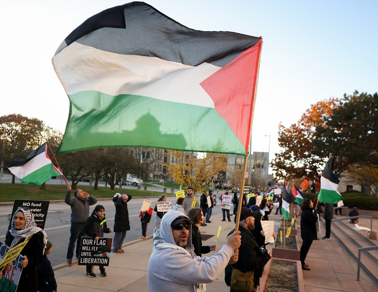 General News - 2nd place - Sylvania resident Fouad Elhady holds up the flag of Palestine during a protest calling for a ceasefire in the Israel-Hamas war outside One Government Center in Toledo. (Kurt Steiss / The Blade)