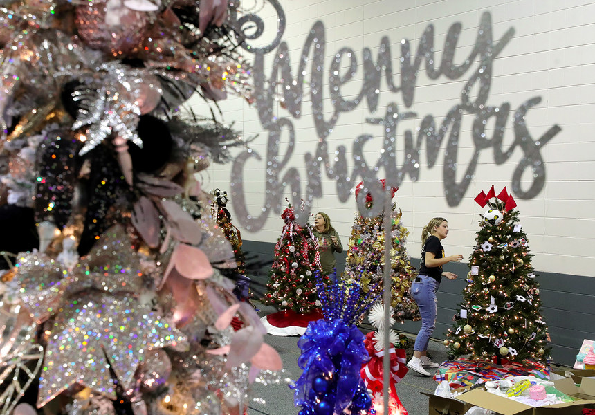 General News - HM - Erika Johnson, head coach of the North High girls soccer team, decorates a world soccer themed Christmas tree ahead of Akron Children’s Hospital’s 42nd annual Holiday Tree Festival at the John S. Knight Center in Akron.  (Jeff Lange / Akron Beacon Journal)