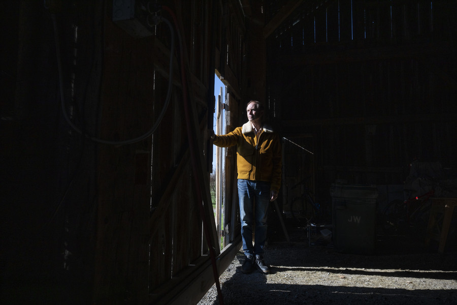 Portrait - 1st place - John Wirchanski enters the main barn on his property. The farm is now surrounded by roundabouts and a nearby Costco and Valvoline, he can hear the traffic from his front door. The Farm has been in his family for four generations, he is considering selling it and moving to the city.  (Brooke LaValley / The Columbus Dispatch)