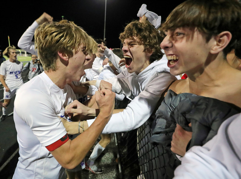 Sports Feature - 3rd place - Revere’s AJ Catlett (left) celebrates with members of the Minutemen student section after beating Mentor Lake Catholic, 2-0, in a Division II state semifinal soccer match, in Twinsburg. (Jeff Lange / Akron Beacon Journal)