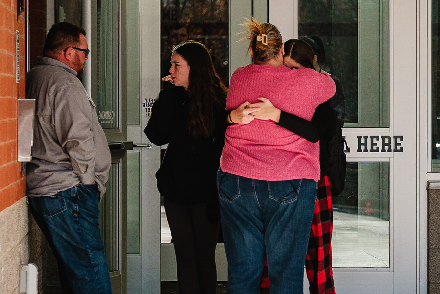 Story - 1st place - Parents and students embrace outside the vestibule at Tuscarawas Valley Middle-High School in Zoarville after learning that three marching band members as well as a teacher, and two chaperones died in a fiery bus crash on Interstate 70, in Licking County – about an hour from the school. The crash was a multi-vehicle, chain reaction crash in which the students were on a charter bus, and the adults were traveling separately in a personal vehicle. (Andrew Dolph / The Times Reporter)