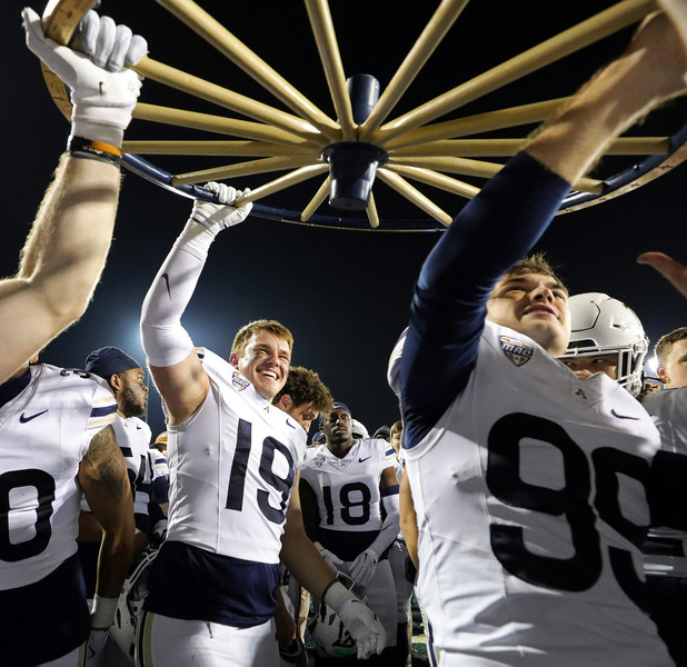 Sports Feature - 2nd place - Akron Zips tight end Grant Gainer (19) celebrates with teammates after beating the Kent State Golden Flashes in an NCAA college football game at Dix Stadium in Kent. (Jeff Lange / Akron Beacon Journal)