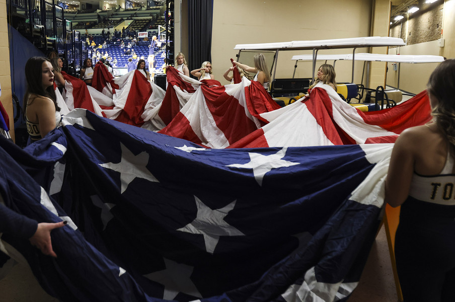 Sports Feature - HM - Toledo dancers hold the American flag for the National Anthem before a men’s college basketball game at Savage Arena in Toledo. (Rebecca Benson / The Blade)