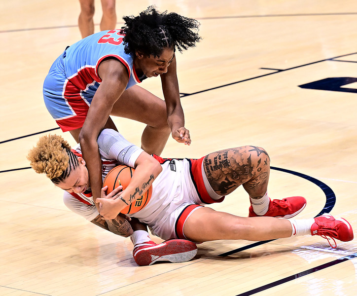 Sports - 1st place - Dayton's Rikki Harris wrestles the ball away from Aubree Murray of Deleware State during the first half of action at UD Arena. Dayton defeated Deleware State 79-44 (Erik Schelkun / Elsestar Images)