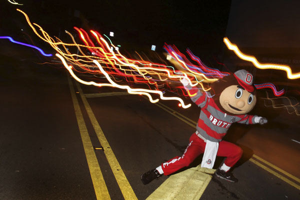 Feature - 3rd place - Brutus Buckeye rallies the crowd as the homecoming parade heads down High St. Columbus. (Eric Albrecht / The Columbus Dispatch)