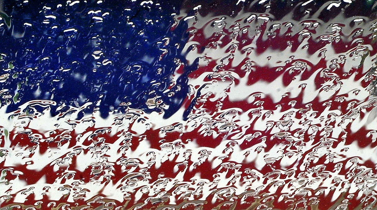 Feature - HM - An American flag mural seen through a rain soaked windshield during a thunderstorm. (Bill Lackey / Springfield News-Sun)