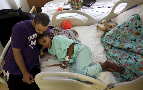 General News - 2nd place - David Pierson holds daughter Amaya Street at Childrens HospitalThe family has recently fallen on hard times. (Eric Albrecht / The Columbus Dispatch)