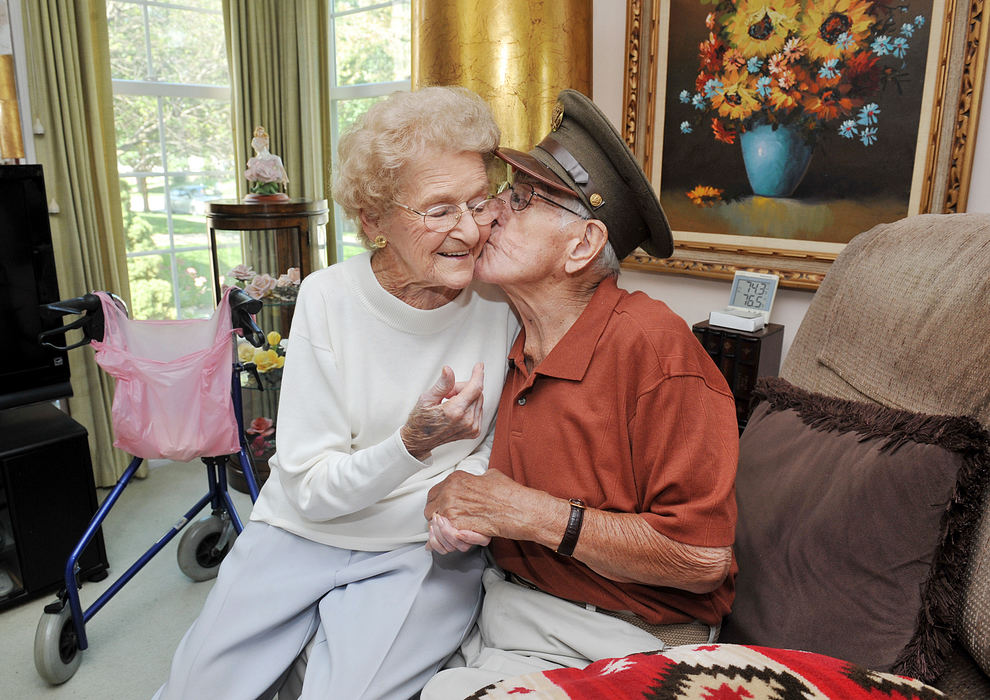 Portrait - 1st place - Joseph Kurilec, 93, Kurilec gives his wife of 66 years, Carol, 89, a kiss on the cheek  after receiving an award for his service with a pin and certificate by the Hospice of Western Reserve. Kurilec served in the US Army during World War II. (Kyle Lanzer / Sun Newspapers)