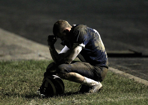 Sports - 3rd place - West Geauga's Nick McDonald mulls over his team's 17-0 impending loss to Chagrin Falls in the final seconds of the fourth quarter at West Geagua High School.  (Lisa DeJong / The Plain Dealer)