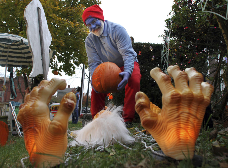 Story - 1st place - Papa Smurf, aka Joe Stewart of Groveport, gets ready for trick or treaters for Beggar's Night at Groveport. This is Stewart's favorite night of the year, he lives a mile away from all the action on Blacklick Road, so each year he decorates his mother's yard in anticipation for 300 to 400 children to stop by for candy and to enjoy his Halloween decorations.  (Neal C. Lauron / The Columbus Dispatch)