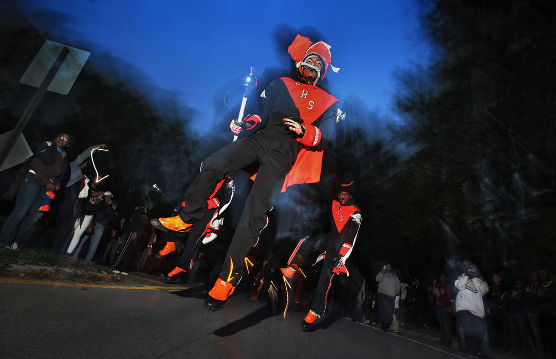 Feature - HMMalik Lewis, drum major for the East High School Tigers, leads the band to the stadium. The school has a tradition of marching through the neighborhoods to the stadium for the homecoming game.  (Eric Albrecht / The Columbus Dispatch)