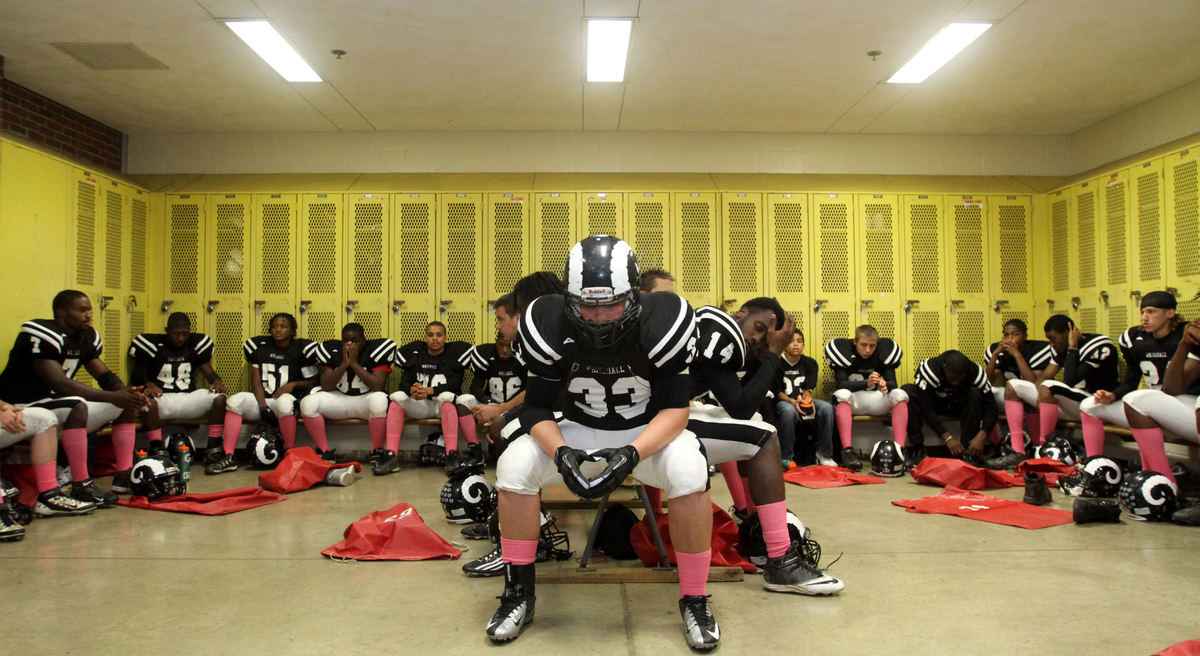 Sports Feature - HMWhitehall's Cameron Barker and the rest of the Rams gather their thoughts in the Gahanna locker room prior to their home game against Newark Catholic.  Whitehall plays their home games on other schools field because of the construction going on the their High School. (Lorrie Cecil / ThisWeek Newspapers)