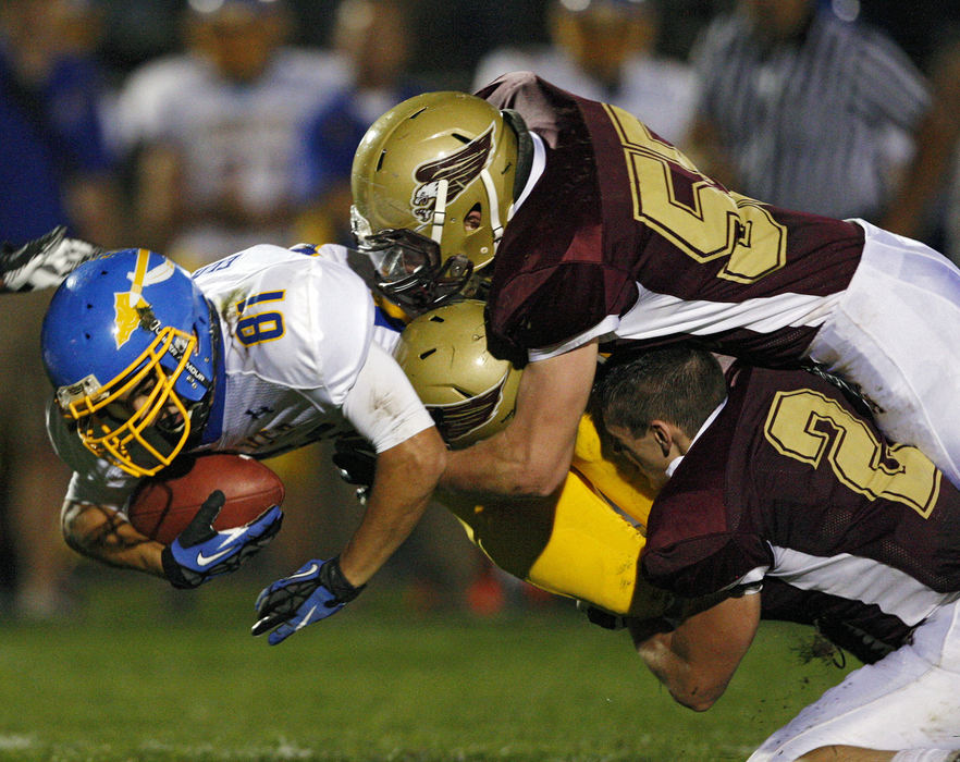 Sports - 2nd placeNew Albany's Nick Clemons (55) and Joe Siegenthaler (2) come together to tackle gets Olentangy's Victor Elmurr (81) after a catch during the 1st half of their game at New Albany High School. (Kyle Robertson / The Columbus Dispatch)