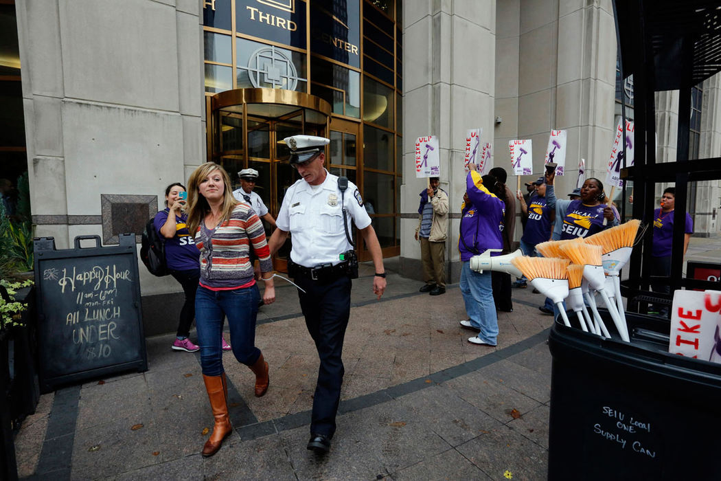 General News - 2nd placeColumbus Police arrest Claire Pollard for criminal trespassing after she and others sat down in the lobby of the Fifth Third Center during a protest of the ABM.  (Tom Dodge / The Columbus Dispatch)