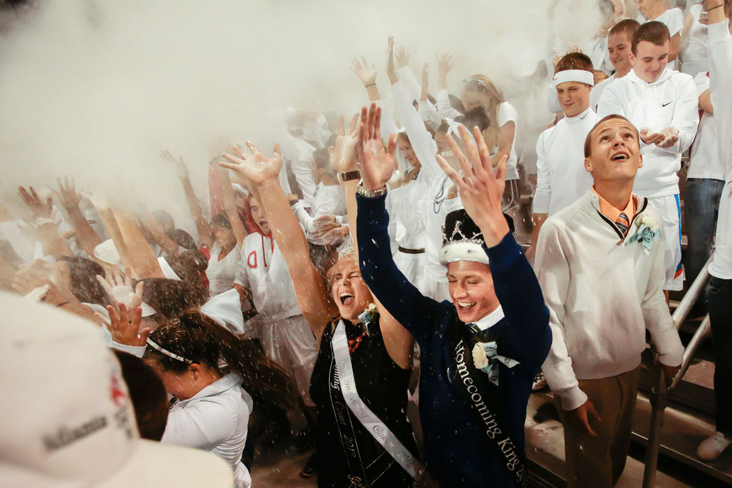 Sports Feature - 2nd placeHilliard Darby Homecoming Queen Savannah Garrett, and King Ryan Baldridge, (center) throw baby powder into the air during kickoff of Darby's football game against Westerville South at Hilliard Darby High School. (Joshua A. Bickel / ThisWeek Newspapers )