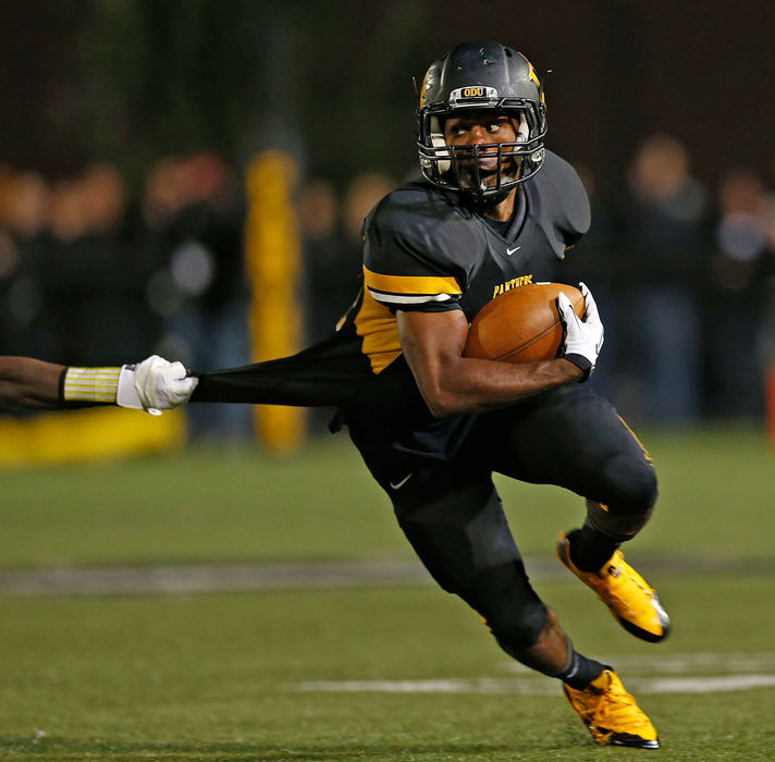 Sports - 3rd placeOhio Dominican's Abe Johnson slips past a Findlay defender on his way to a large gain in the first half at Panther Field. (Chris Russell / The Columbus Dispatch)