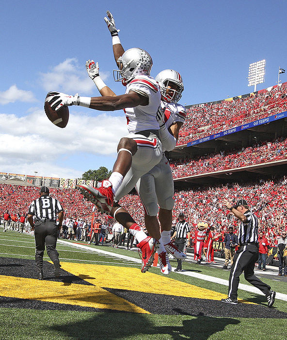 Sports Feature - 3rd place - Ohio State wide receiver Michael Thomas (left) and  running back Jalin Marshall celebrate Thomas's touchdown catch in the second quarter at Byrd Stadium in College Park Maryland. (Chris Russell / The Columbus Dispatch)