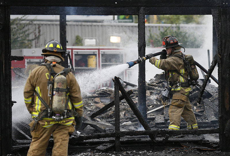 Spot News - 3rd place - The Columbus Fire Department extinguishes a fire at Inn Rehab Wingin' it Grille on Greenlawn Avenue, just west of I-71 on Columbus' southwest side. The fire completely destroyed the rear of the structure, which was mainly a patio and seating area.  (Adam Cairns / The Columbus Dispatch)