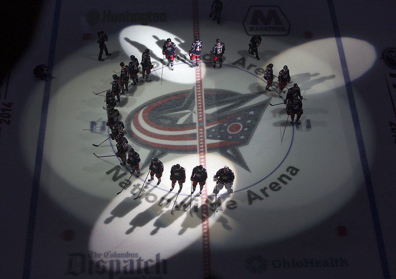 Story - 2nd place - Columbus Blue Jackets players meet at center ice before the start of their home opener against New York Rangers at Nationwide Arena in Columbus. (Kyle Robertson / The Columbus Dispatch)