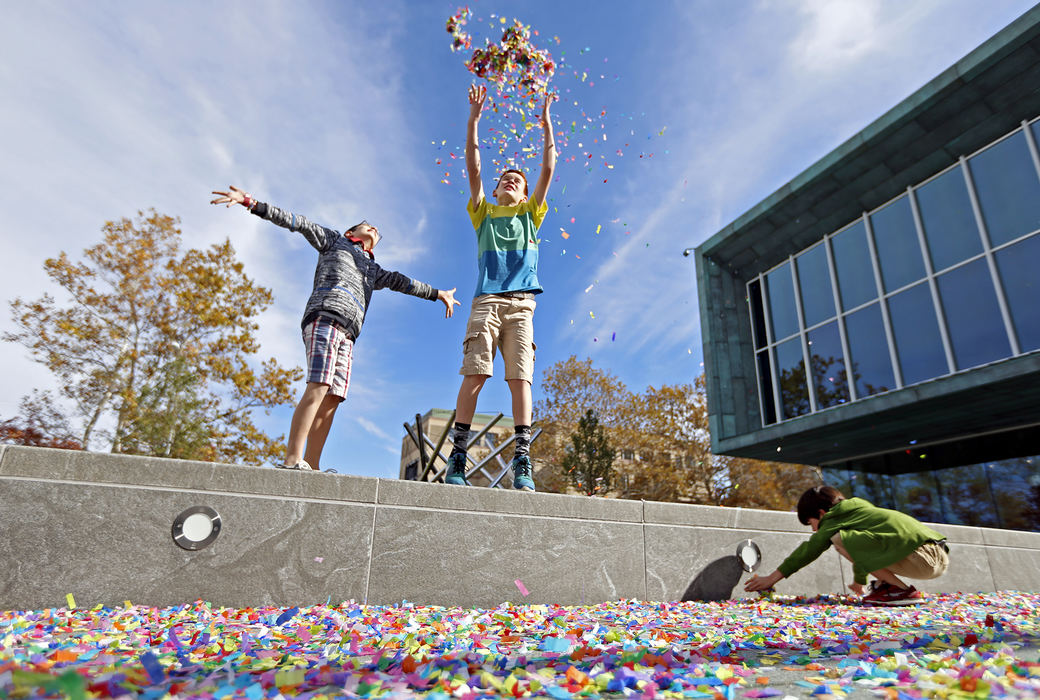 Feature - 2nd place - From left: Santiago, 9, Diego, 13, and Amelio Bernard of Hilliard play with confetti outside of the Columbus Museum of Art during the grand opening of the CMA expansion. The museum hosted a free community party featuring the unveiling of the new Margaret M. Walter Wing. (Leah Klafczynski / The Columbus Dispatch)