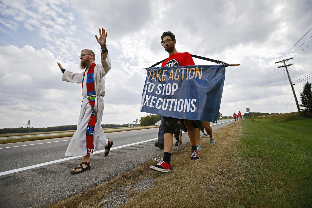 AGeneral News - 2nd place - On their way from the Lucasville Penitentiary to the Statehouse in Columbus, Baptist minister Jeff Hood, 31, from Denton, Texas (left) and Jim Matzorkis, 30, of Cleveland lead a group of approximately 15 people along the side of Rt. 23 north of Circleville, Ohio . The group is making the 6-day march in protest of Ohio's death penalty laws.  (Adam Cairns / The Columbus Dispatch)