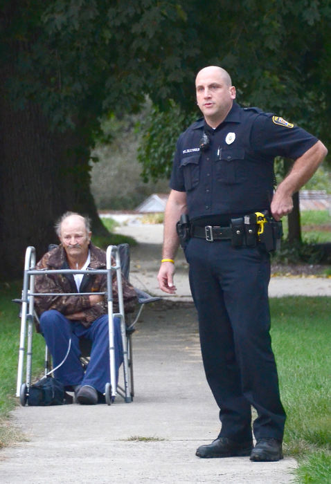 Spot News - 2nd place - Lisbon police officer Jason Sletvold assisted David and Karen Hayes in the evacuation of their Beaver Street home as firefighters battled a blaze in the neighboring building at 215 Beaver St. Mr. Hayes is on oxygen after recently having undergone surgery.  (Patricia Schaeffer / The (Lisbon) Morning Journal)