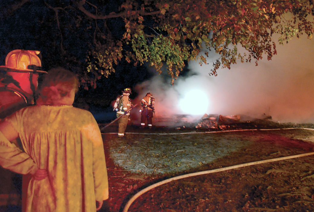 Spot News - 3rd place - A distraught Katherine Brown watches the irreplaceable photographs of her mother and grandmother burn in a fire that struck the old house she recently purchased and was remodeling. Brown was asleep in the trailer next to the house when her nephew awakened her to the fire.  (Patricia Schaeffer / The (Lisbon) Morning Journal)