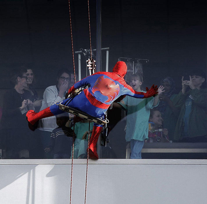 Feature - HM - Jose Banegas of  Columbus Window Cleaning Company dressed as "your friendly neighborhood Spider-Man" entertained people as he descended down the 12 patient floor tower of Nationwide Children's Hospital. (Tom Dodge / The Columbus Dispatch)