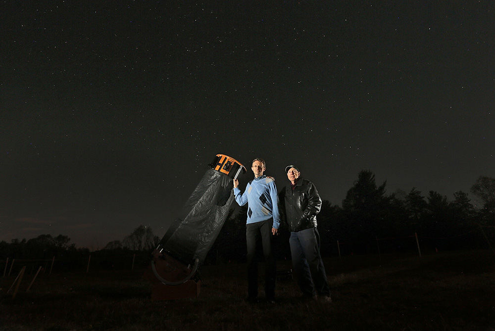 Portrait - 3rd place - Brad Hoehne, past president of the Columbus Astronomical Society (left) and Clyde Gosnell, a retired architect and part of the Friends of the Hocking Hills group, pose with Hoehne's telescope on the land where they hope to build The John Glenn Observatory and Astronomy Park in Hocking Hills. (Jonathan Quilter / The Columbus Dispatch)