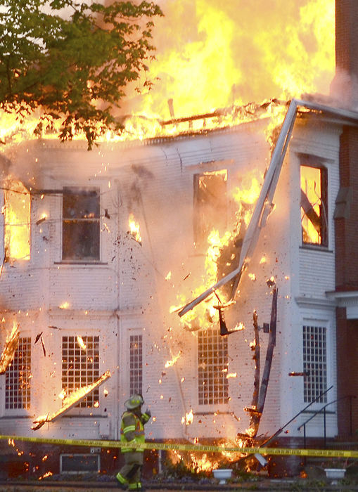 Spot News - 2nd place - Part of the north side of the historical McKeefrey Mansion collapses as a firefighter walks by on his way to the truck.  (Patricia Schaeffer / The (Lisbon) Morning Journal)