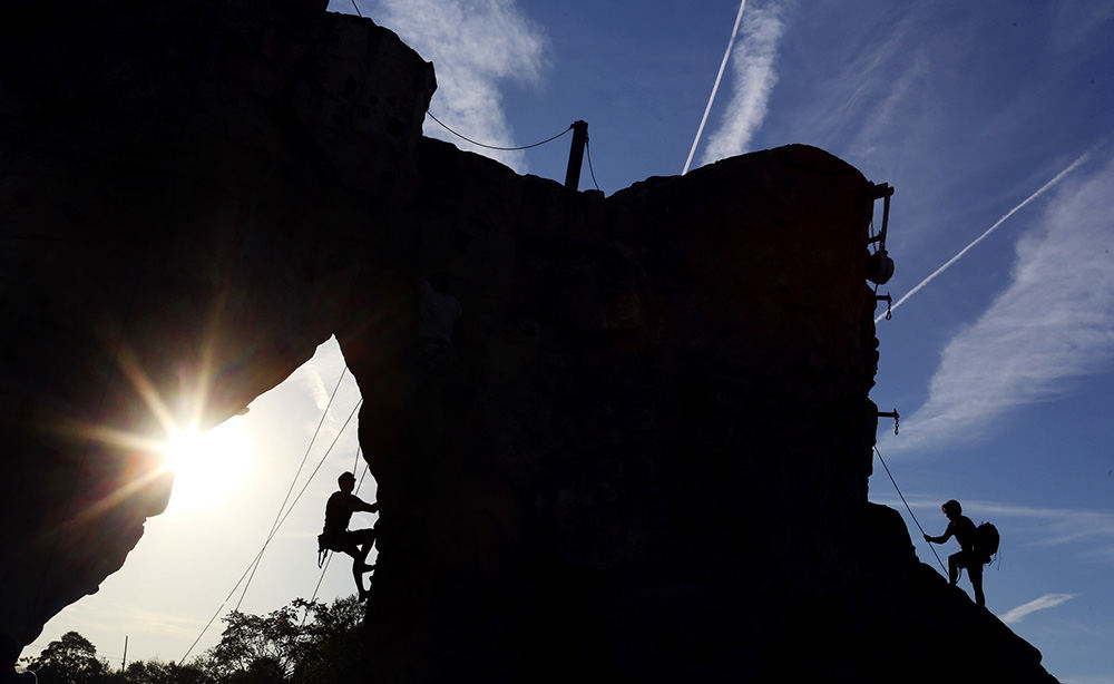 MT Feature - 1st place - Climbers take advantage of clear evening to practice climbing skills at Scioto Audubon Park in Columbus. The wall was reopened after a two week renovation to the crash pad. (Eric Albrecht / The Columbus Dispatch)