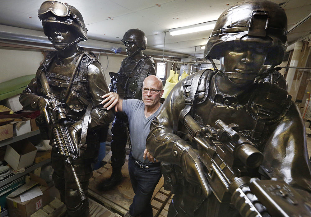 Portrait - 2nd place - Alan Cottrill, a well-known Zanesville sculptor, has been commissioned by the National Infantry Museum in Georgia to do nine seven-foot sculptures of combat soldiers for the Global War on Terror Memorial. Cottrill poses in his studio with some of the finished statues. (Fred Squillante / The Columbus Dispatch)