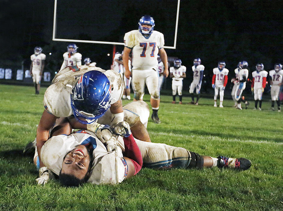 Sports Feature - 1st place - Chad Douglas (57) and Daleron McCarrell (1) of Independence celebrate following a 44-34 win over Walnut Ridge. Independence secured the City League South title with the win. (Barbara J. Perenic / The Columbus Dispatch)