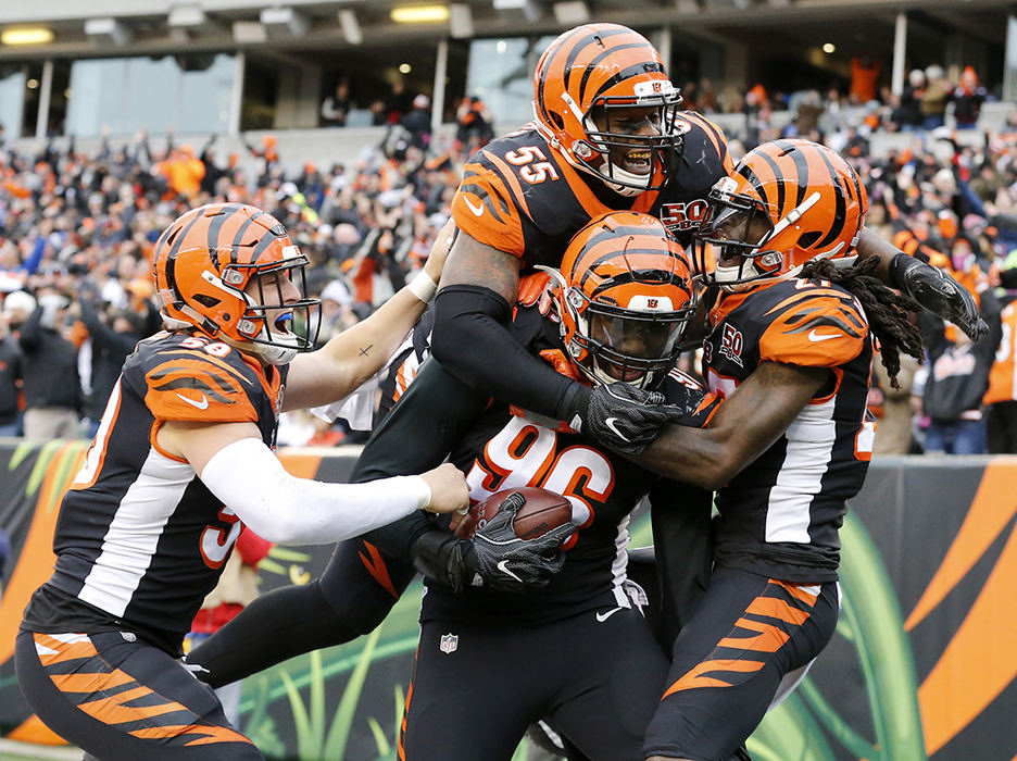 SSports Feature - 2nd place - The Cincinnati Bengals defense jumps on the back of defensive end Carlos Dunlap (96) after he returned an interception for the go-ahead touchdown in the fourth quarter against the Indianapolis Colts at Paul Brown Stadium in Cincinnati. (Sam Greene / Cincinnati Enquirer)