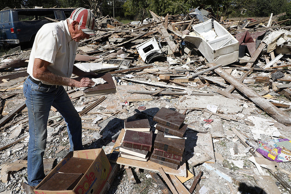 Spot News - 3rd place - "I'm surprised most of them survived." Herb Hoover said as he collects his set of encyclopedias from what's left of his 200 year old house Friday. The house located on Lower Valley Pike was completely destroyed when it exploded Thursday night due to a gas leak.  (Bill Lackey / Springfield News-Sun)