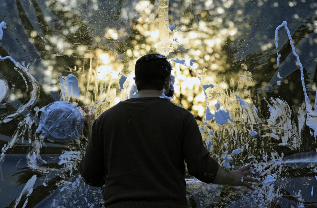 Feature - 2nd place - Rabbi Mendy Kaltmann waits to get a shaving cream cake into the face at the "Cake the Rabbi" booth during a drive-thru carnival for Jewish holiday of Sukkah at Lori Schottenstein Chabad Center in New Albany. Kyle Robertson / The Columbus Dispatch