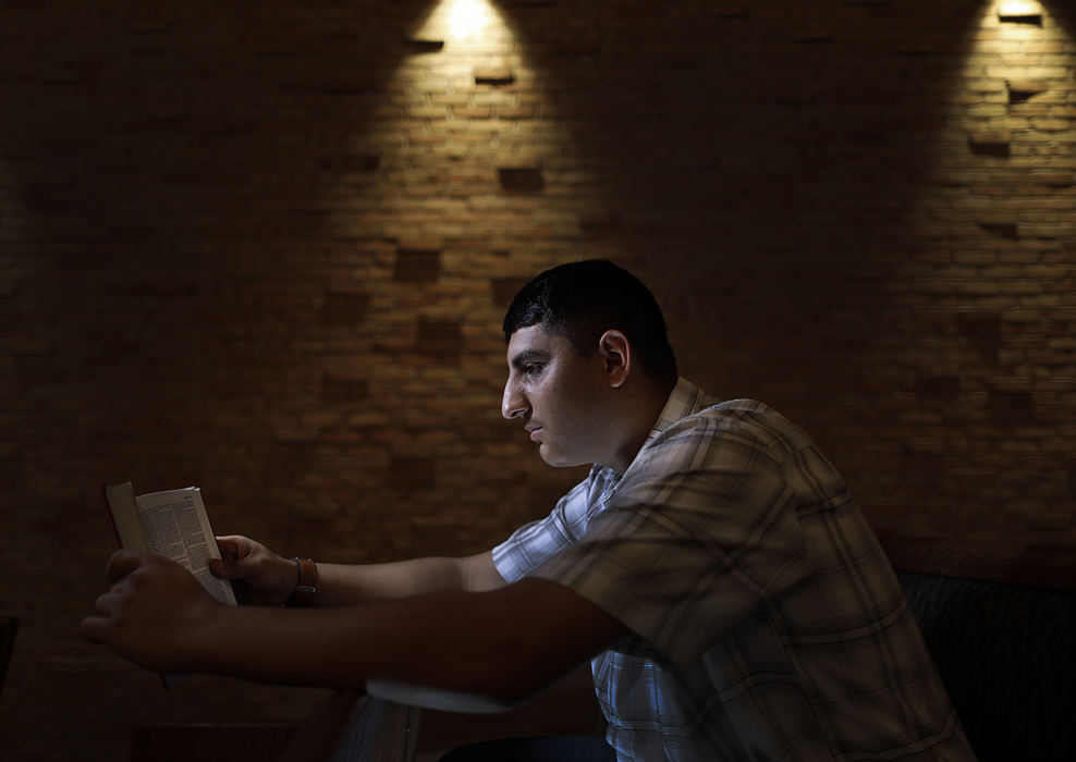 Portrait - 2nd place - Robert Scott, 19, reads a John 3:16 quote from the Bible at Faith Memorial Church in Lancaster. Robert has been involved in Central Ohio Youth for Christ's Juvenile Justice Ministry. He has been in the Juvenile Detention Center and is one of the kids who has benefited from the volunteer chaplains who spent time with these kids. Kyle Robertson / The Columbus Dispatch