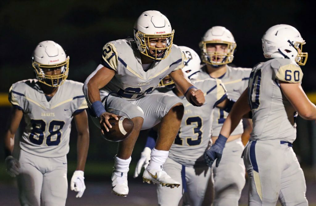 Sports Feature - HM - Hoban running back Victor Dawson (center) celebrates after scoring a touchdown during the second half against Walsh Jesuit High School in Cuyahoga Falls. Jeff Lange / Akron Beacon Journal