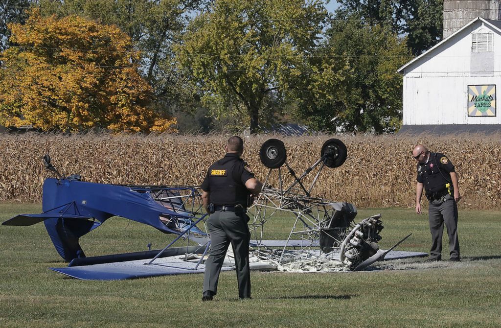 Spot News - 3rd place - Clark County Sheriff's deputies look over the remains of a single engine airplane that crashed while landing and burst into flames Tuesday at the New Carlisle Airport. The pilot and passenger escaped with non-life threatening injuries.  Bill Lackey / Springfield News-Sun