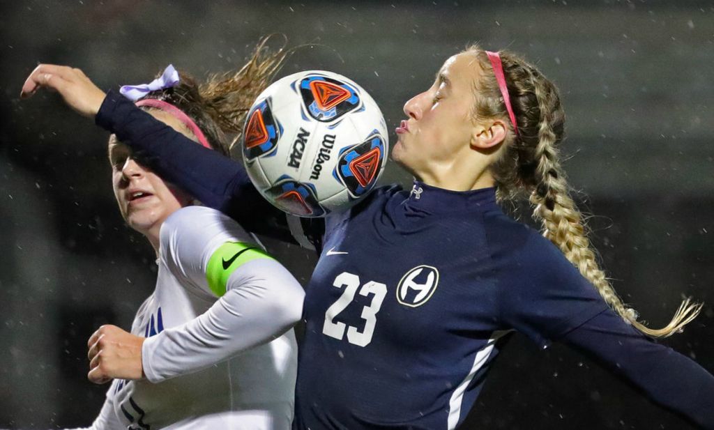 Sports - 3rd place - Hoban forward Miriam Szijarto (right) makes a play for the ball against Hudson's Kali Sweet during the second half of a Division I district final soccer match in Akron. Jeff Lange / Akron Beacon Journal