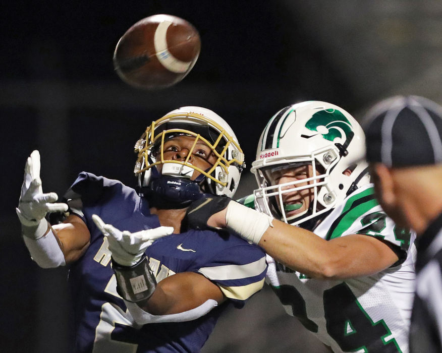 Sports - HM - Hoban receiver Kharion Davis (left) loose in a 42-yard touchdown pass against Mayfield safety Grant Woods during the first half of a Division II playoff game at Dowed Field in Akron. Jeff Lange / Akron Beacon Journal