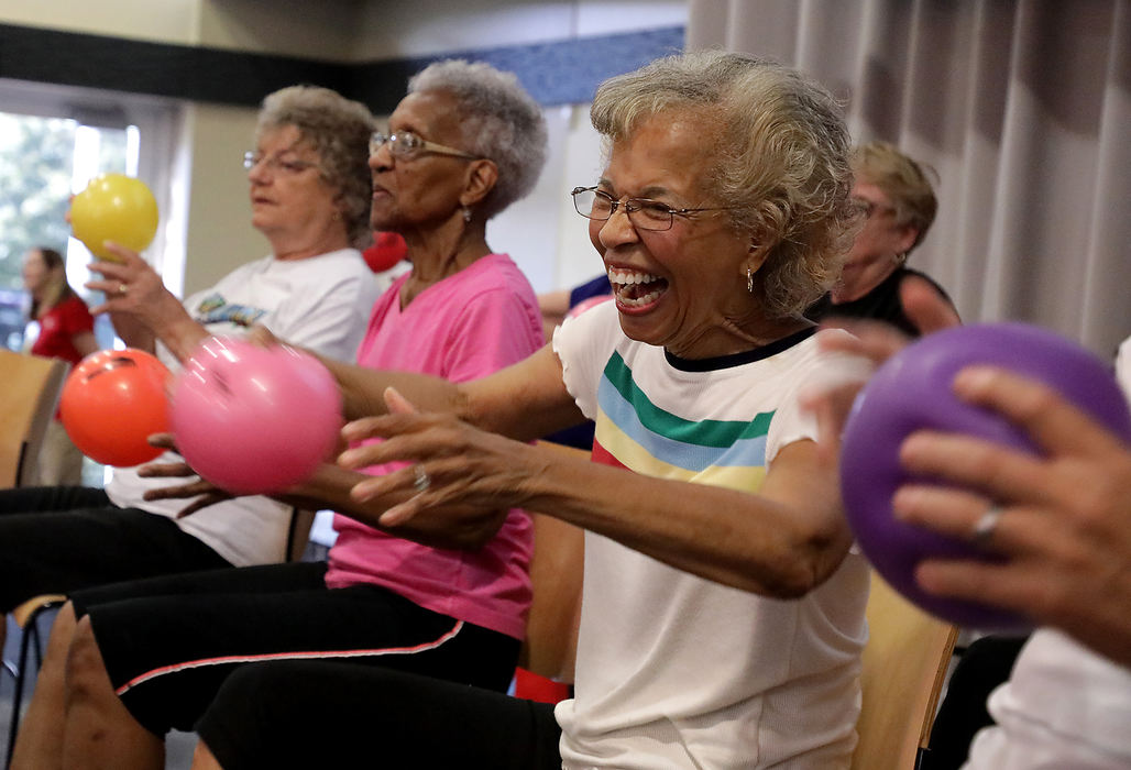 Feature - HMVarga Berrien laughs as she does aerobics for seniors with a group on stage at the Community Health Foundation's annual Health Expo at the Hollenbeck Bayley Conference Center.  (Bill Lackey / Springfield News-Sun)