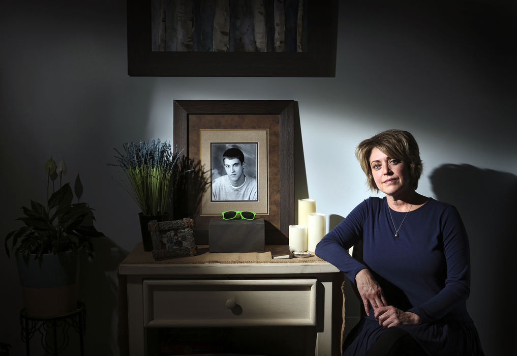 Portrait - 1st placeTina Rossi in her Galloway home with a shrine to her son Vince Rossi who lost his life to opioids, the green sunglasses are reminder of the positive times she had with her son who wore them on a family canoe outing.With lawsuits beginning to be settled Tina and other families who have lost loved ones to opioids are wondering where the fit into the settlement situation. (Eric Albrecht / The Columbus Dispatch)