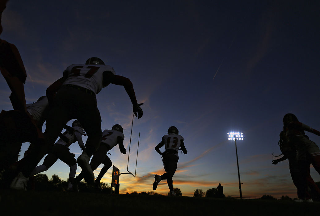 Sports Feature - 2nd placeWalnut Ridge's Qian Magwood (13) leads his team to the field before their game against Marion-Franklin. (Kyle Robertson / The Columbus Dispatch)