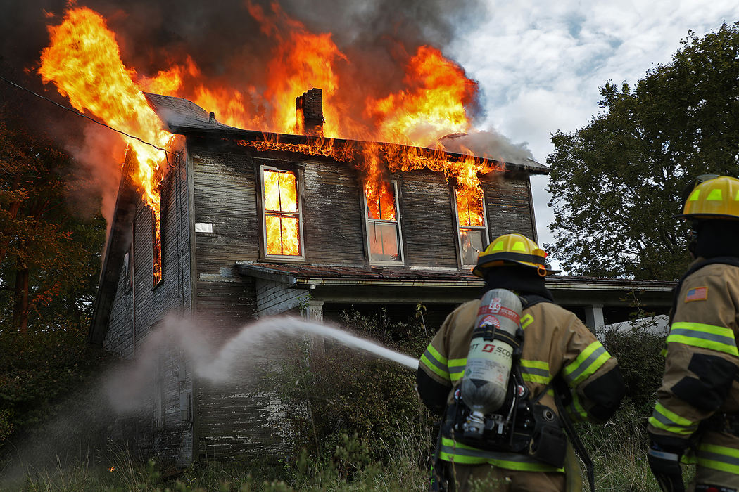 Spot News - 2nd placeMoorefield Township firefighters battle a fire in a vacant house on Mechanicsburg Road. The second floor was fully involved when the fire department arrived and firefighters were forced to attack the fire from the outside for safety reasons. Once the fire had taken over the entire second floor, the fire department decided to let the vacant structure burn and just contain it. (Bill Lackey / Springfield News-Sun)