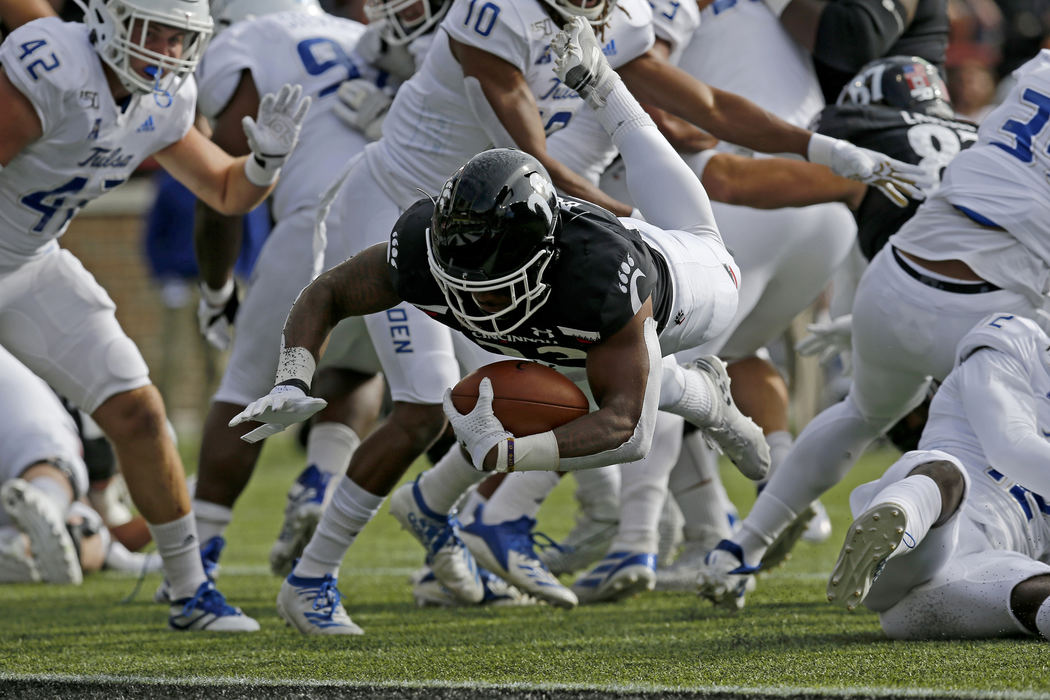 Sports - 1st placeCincinnati Bearcats running back Gerrid Doaks (23) dives into the end zone for a touchdown in the first quarter against the Tulsa Golden Hurricane at Nippert Stadium in Cincinnati. (Sam Greene / The Cincinnati Enquirer)